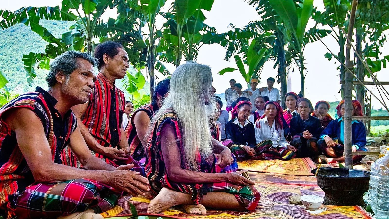 Bru-Vân Kiều elders in traditional meeting under the trees.