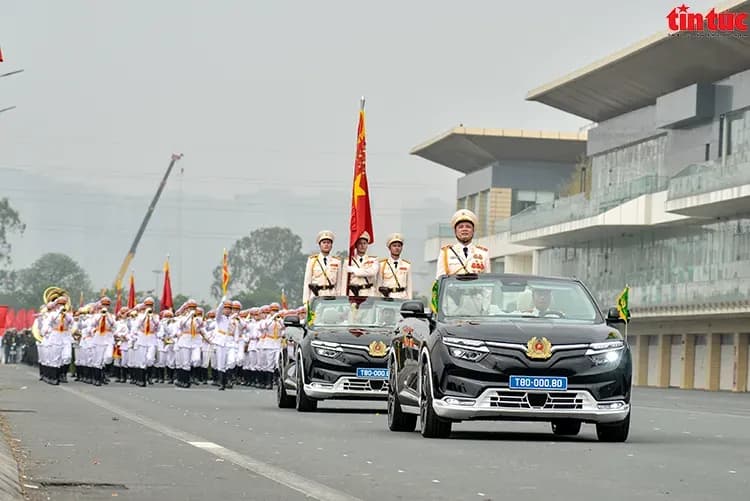 Car procession with the military marching, showcasing strength and unity.