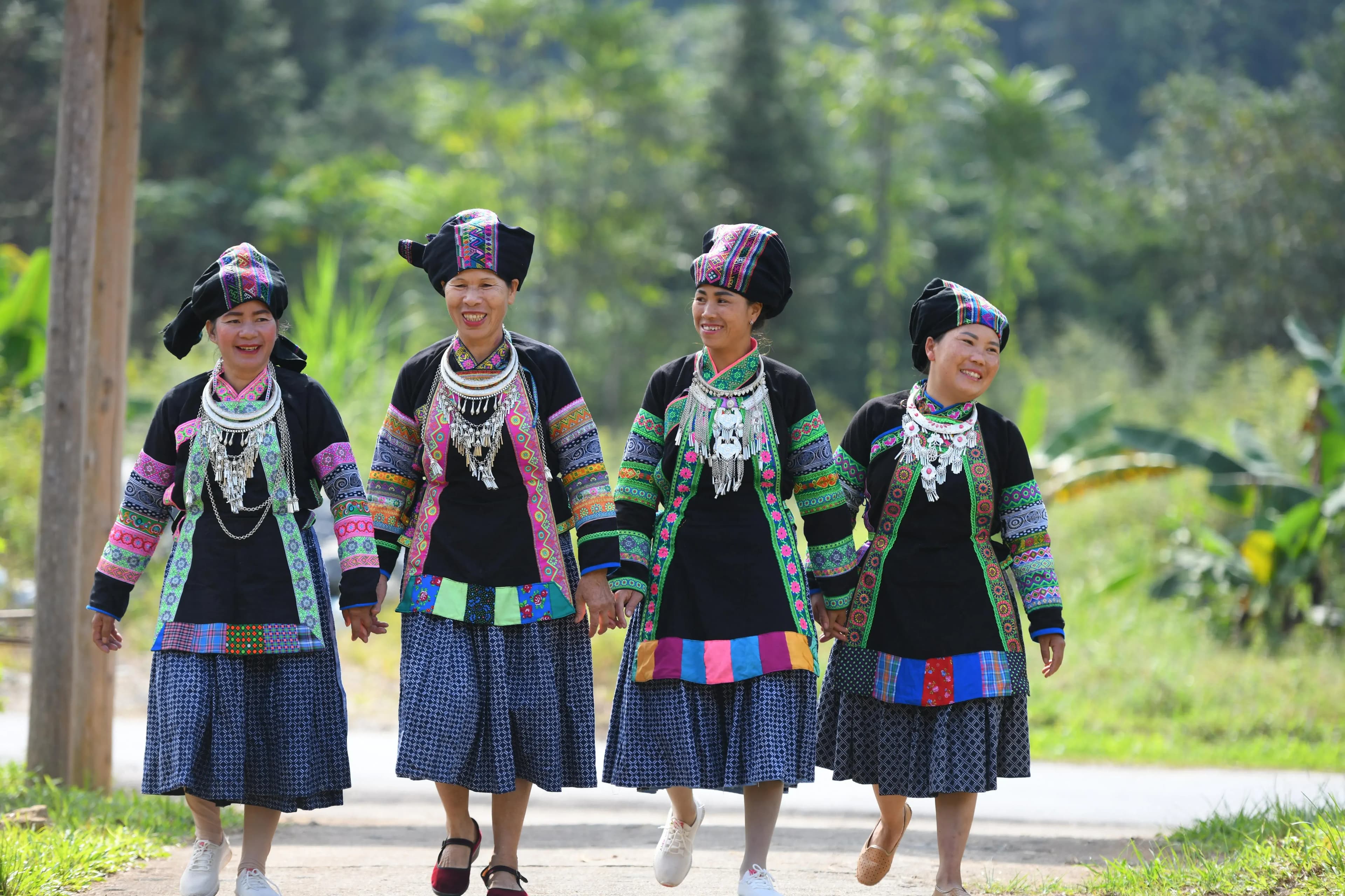 The Bo Y women in vibrant traditional attire.