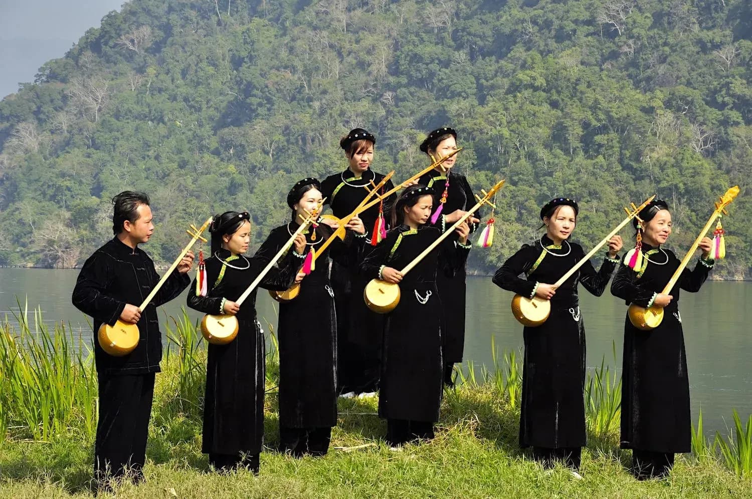 The performer plays the "masculine" by a majestic river.  