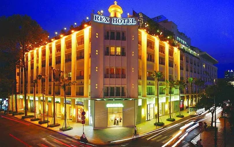 The Rex Hotel Saigon glows at night with French architecture and modern lighting.  