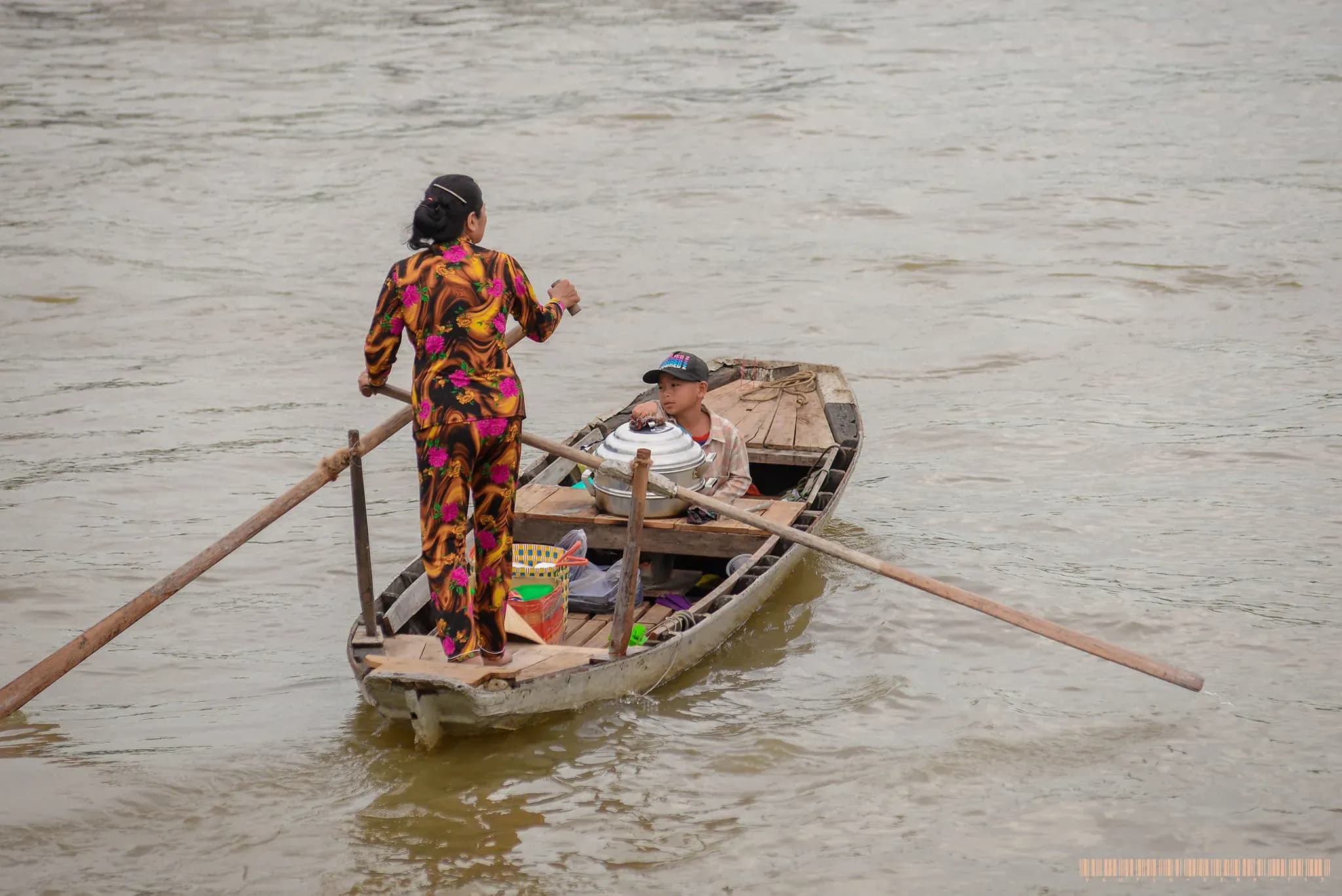 Early morning at Cai Rang Floating Market, bustling with tourists and vibrant scenes of trade, featuring an array of fresh fruits, bread, and livestock on boats
