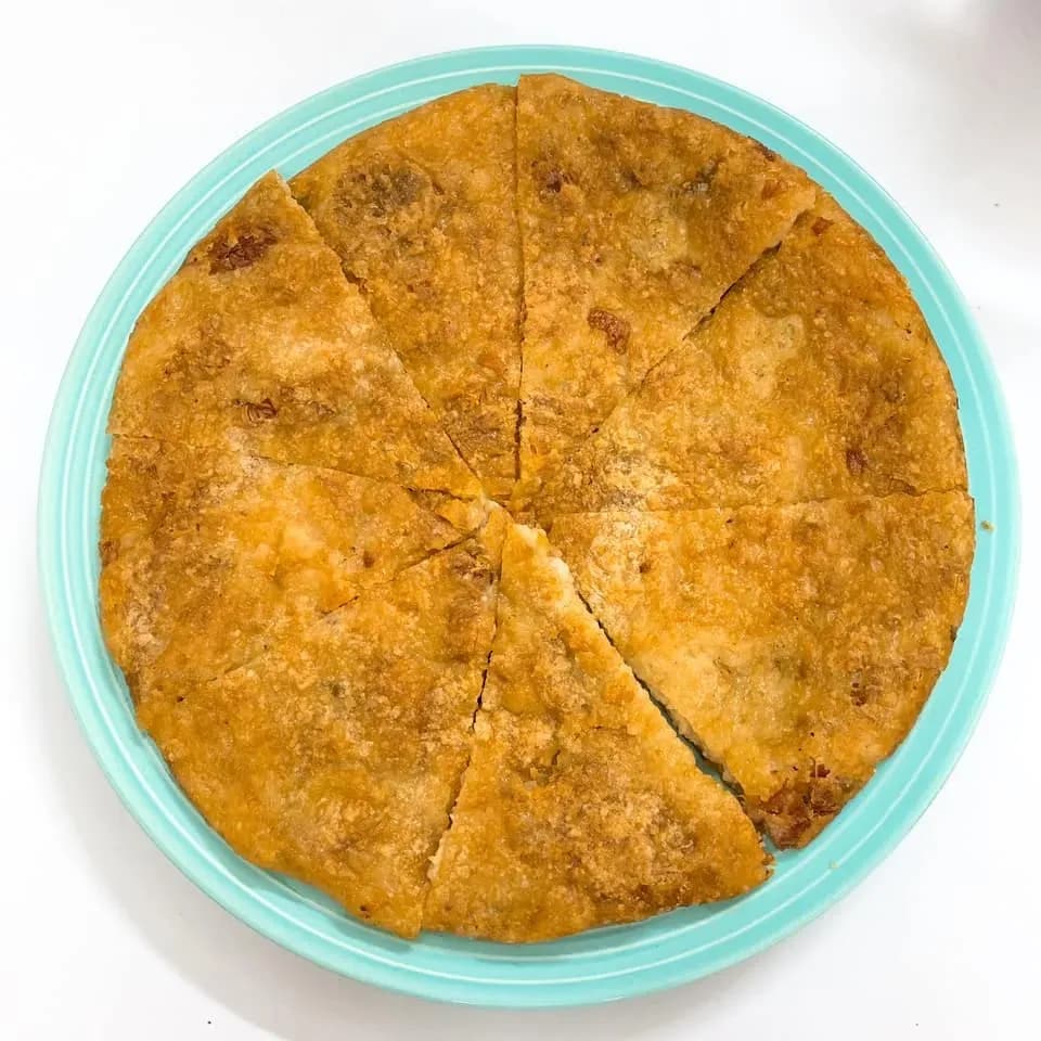 Banh chung ran is a crispy fried version of traditional banh chung, with a golden outer layer and a soft, flavorful filling, often enjoyed as a snack during the Lunar New Year.