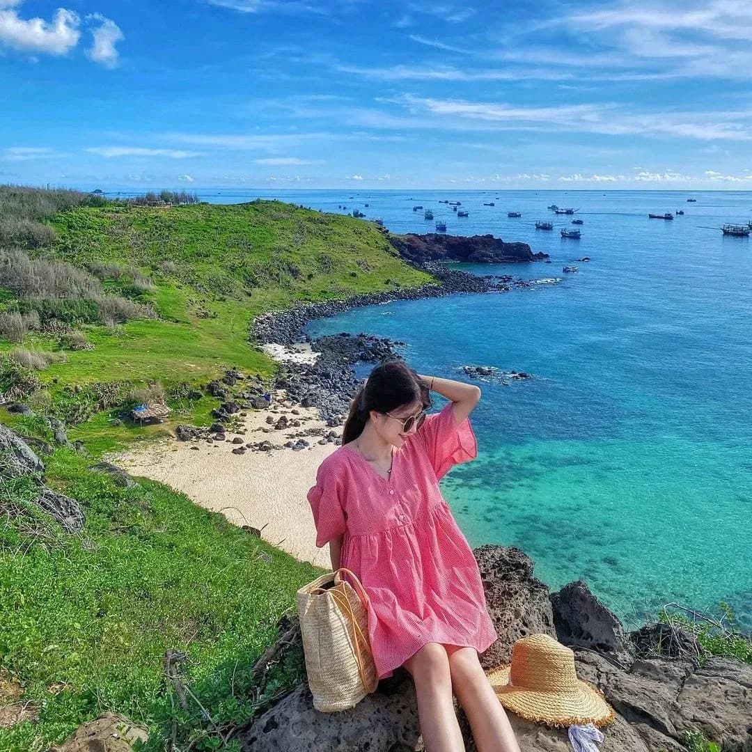 Tourists enjoy the clear blue sky and peaceful sea on Phu Quy Island