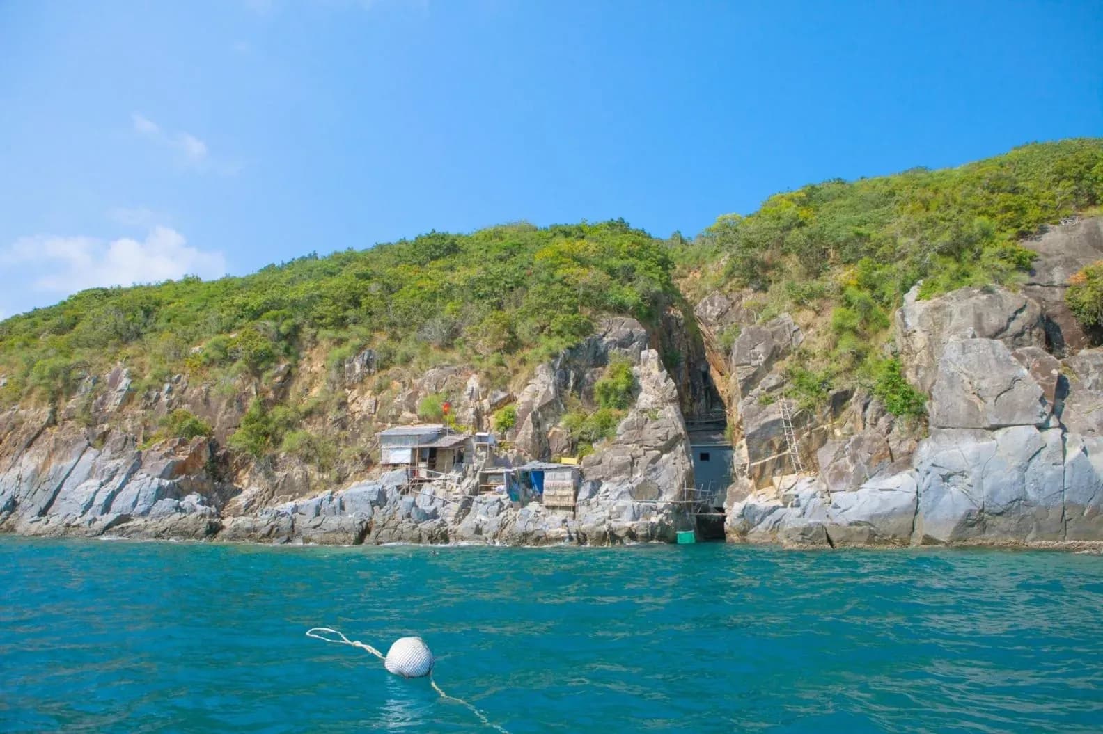 Mountains surround the peaceful sea at Robinson Island Nha Trang