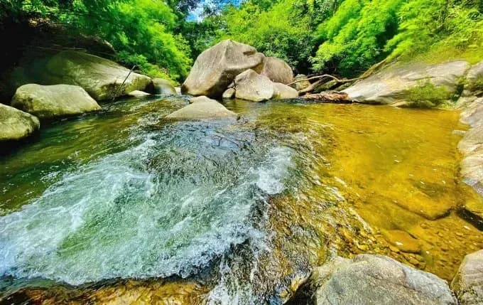 Crystal-clear stream with natural rock formations at Savin.