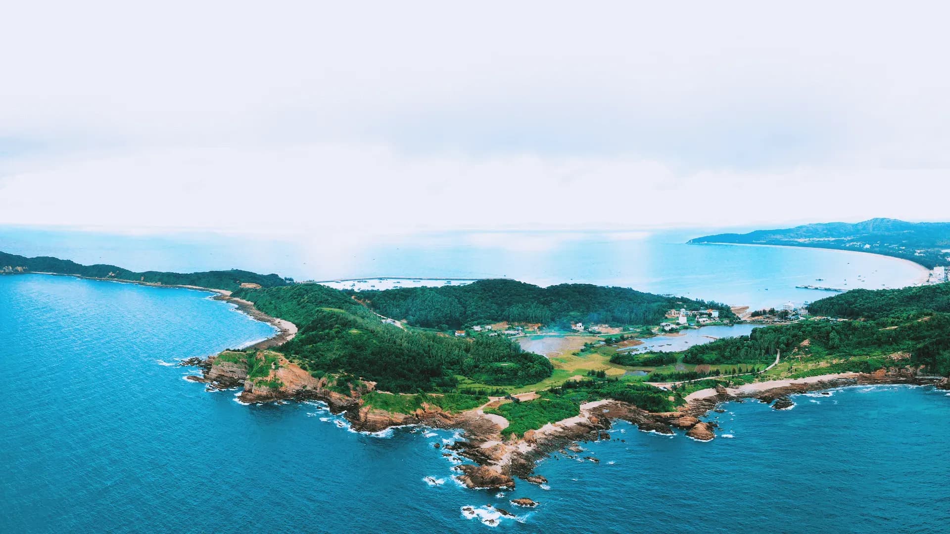 Spectacular view of Cô Tô Island's pristine nature with lush forests and azure sea.