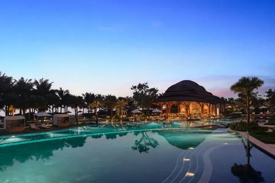 Stunning pool at New World Hoiana Beach as the sun sets.