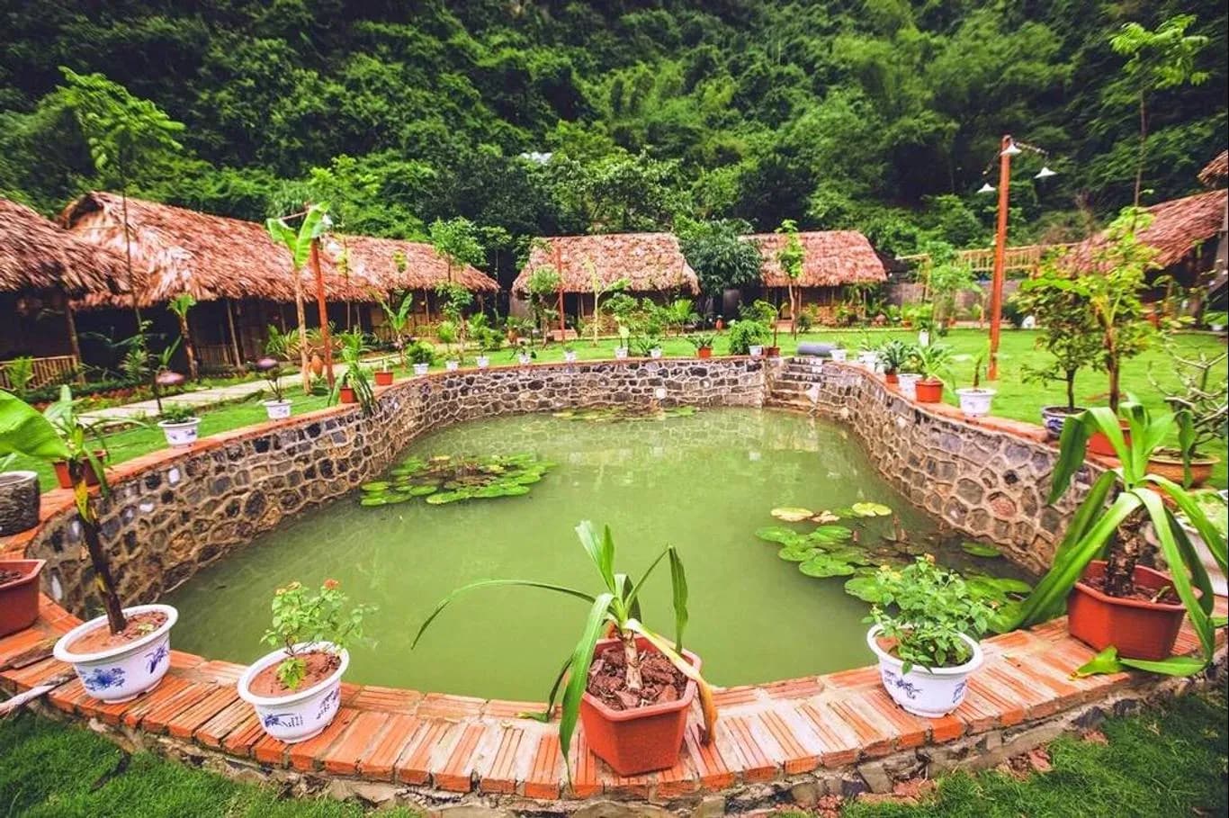 A resort featuring village-style architecture by a serene pond.