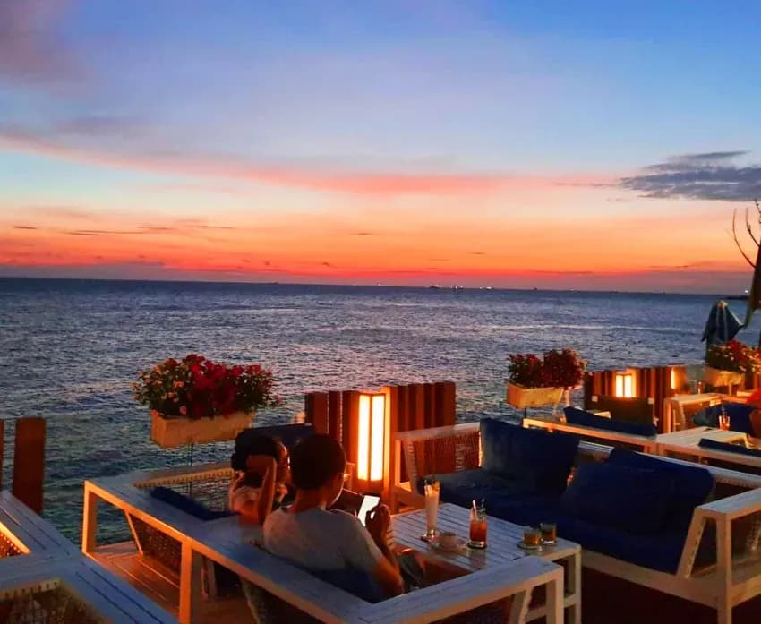 Sip your drink under the gentle sunset glow.