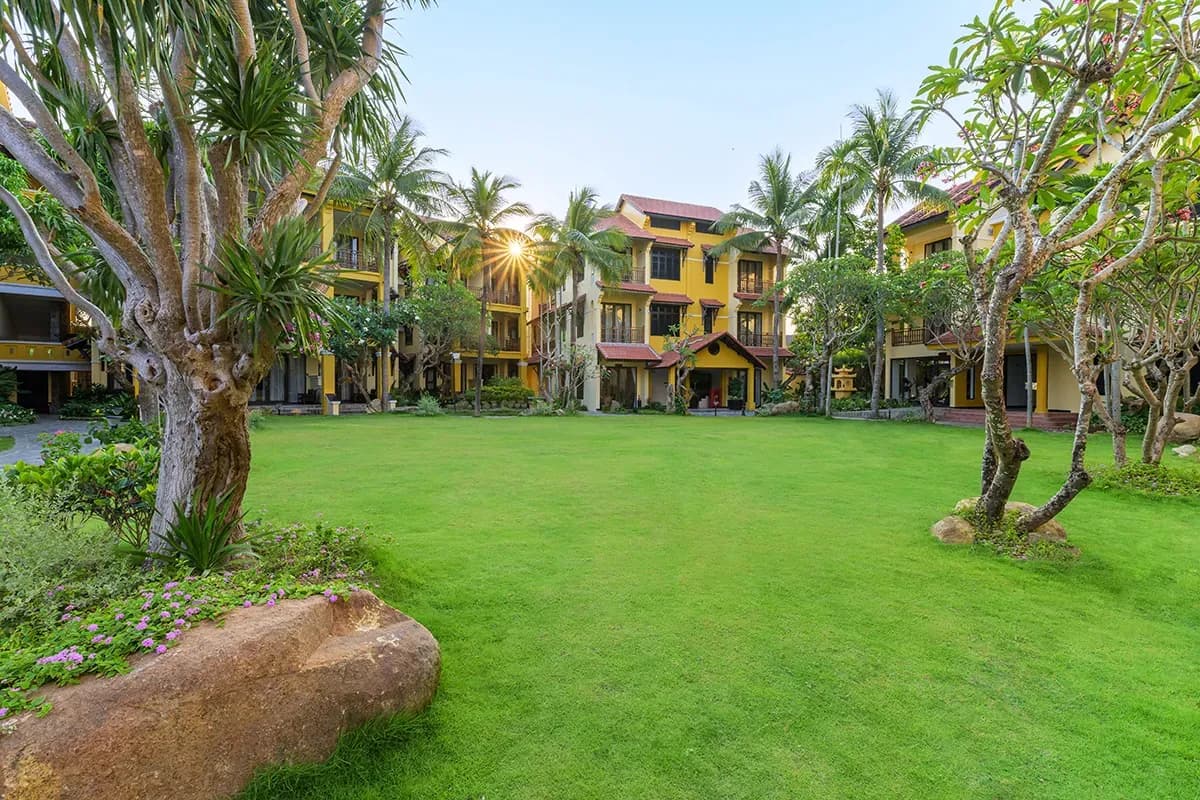 Lush garden at the resort with radiant sunrise.