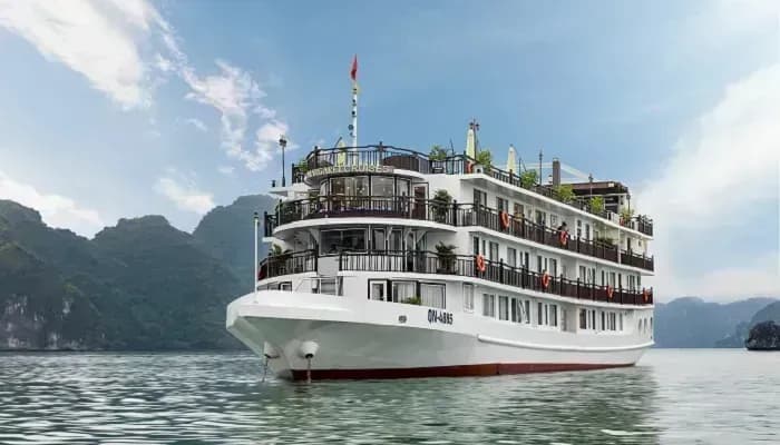 Luxury cruise cruising through Ha Long Bay, with majestic mountains in the background.