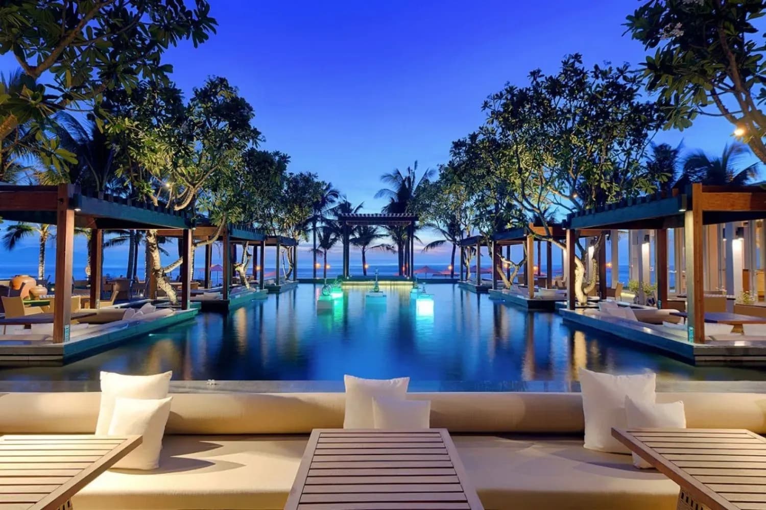 Luxurious resort pool with shimmering lights and a relaxing atmosphere.