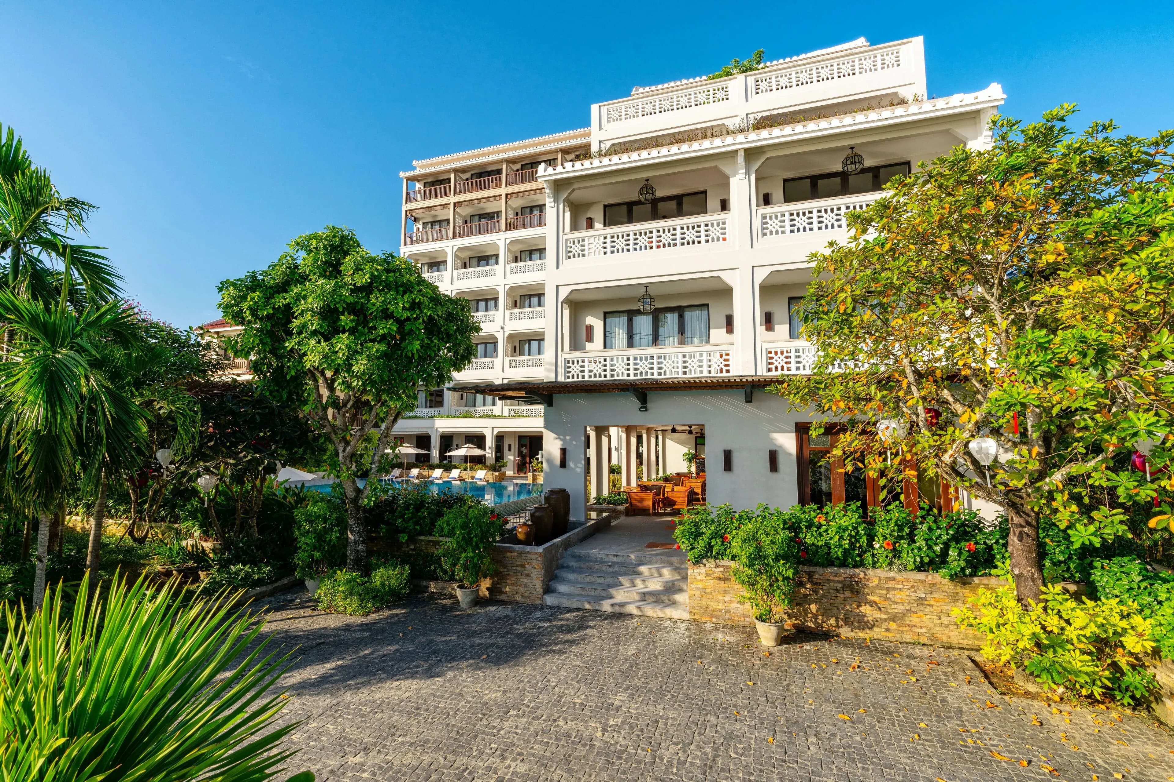 Modern design of RiverTown Hoi An Resort amidst lush greenery.