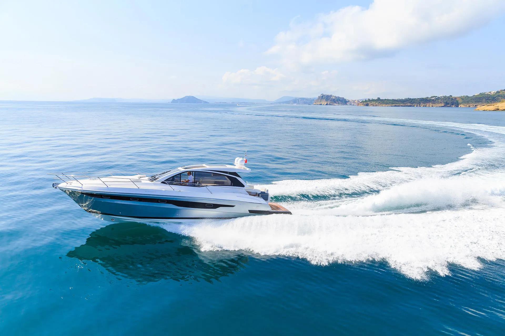 A private yacht gliding through the crystal-clear waters of Nha Trang, with scenic coastal views and distant islands on the horizon