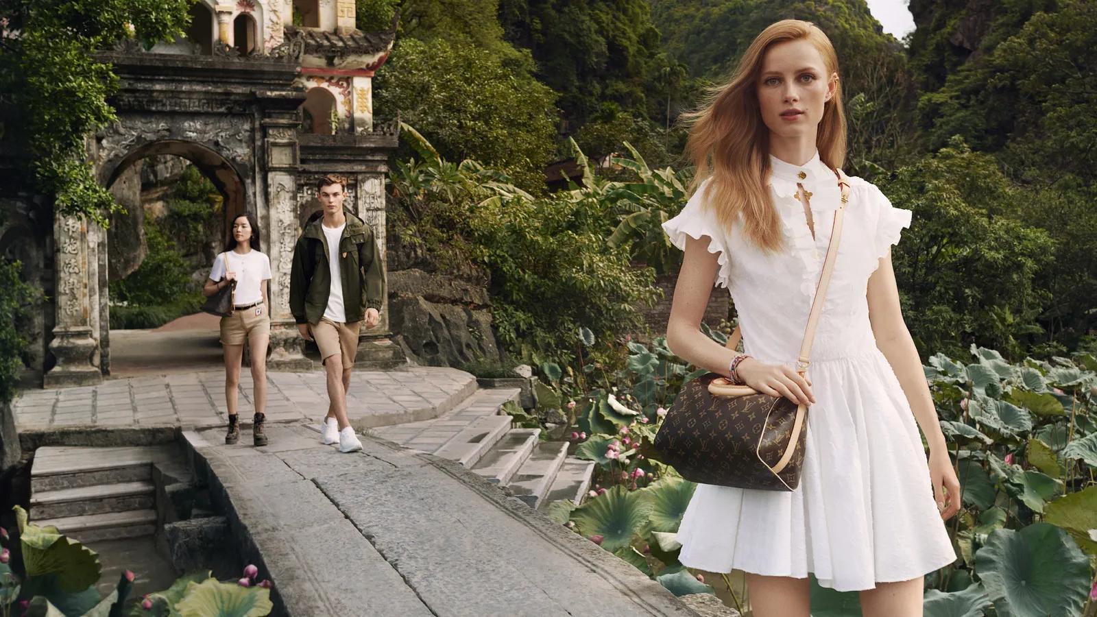 A Louis Vuitton model striking a pose against the stunning backdrop of Ninh Binh’s limestone karsts and lush greenery, blending high fashion with Vietnam’s natural beauty