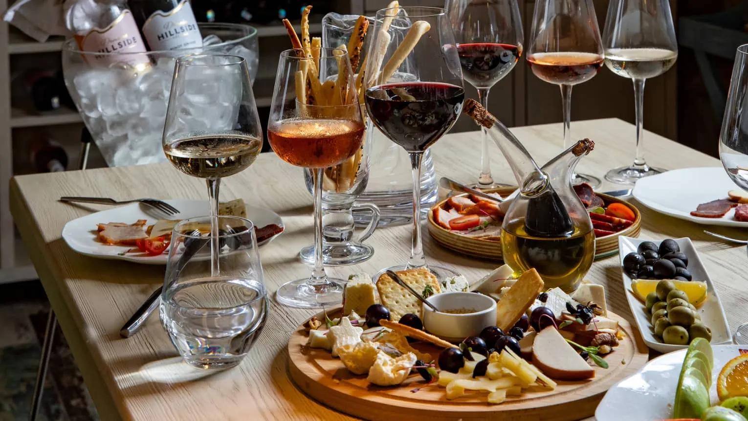A luxurious wine tasting setup with elegant glasses and fine wines displayed on a polished table, set in a sophisticated environment