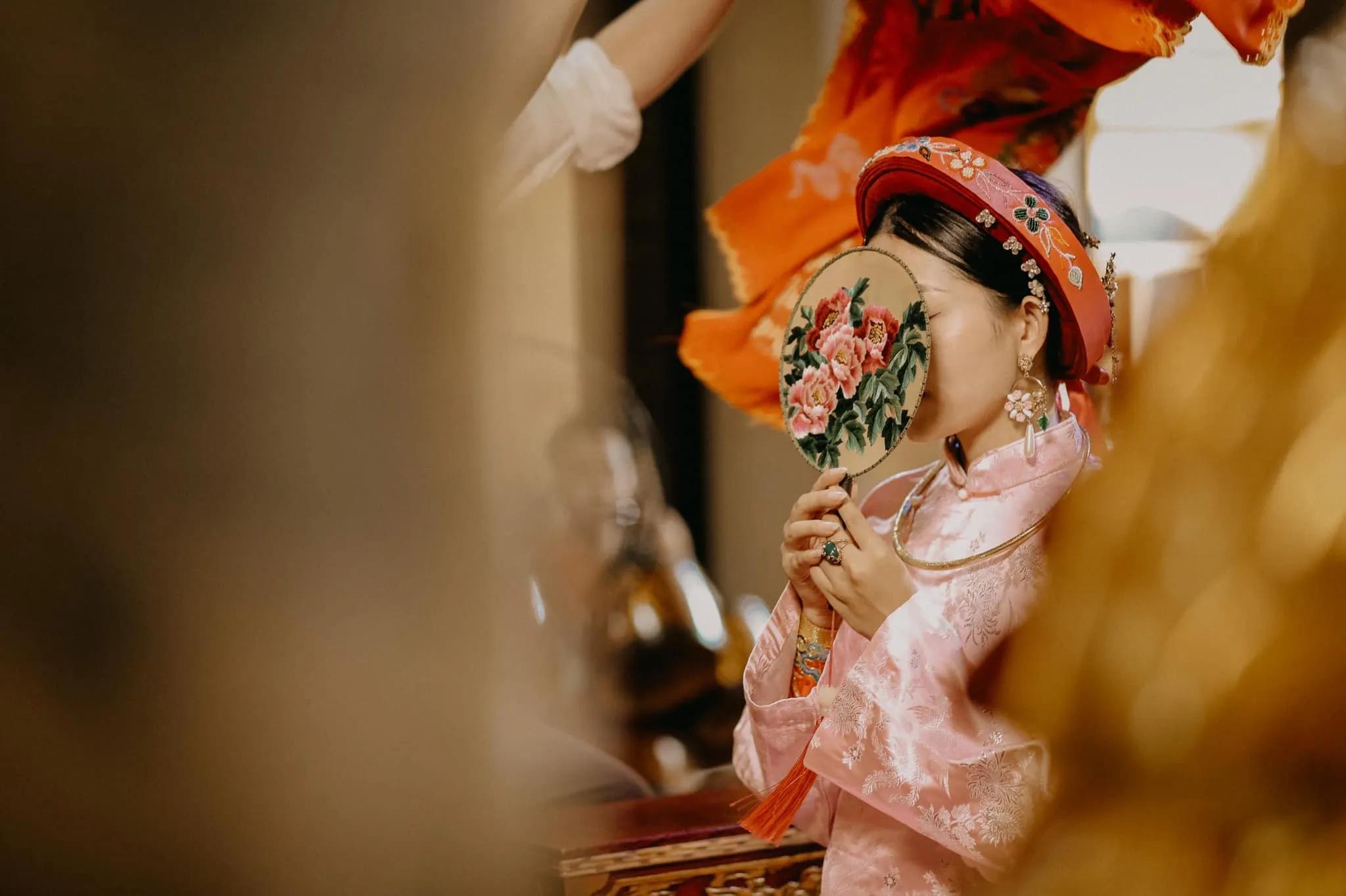A traditional hầu đồng ritual in full display, with vivid costumes, offerings, and ceremonial objects set against a sacred backdrop