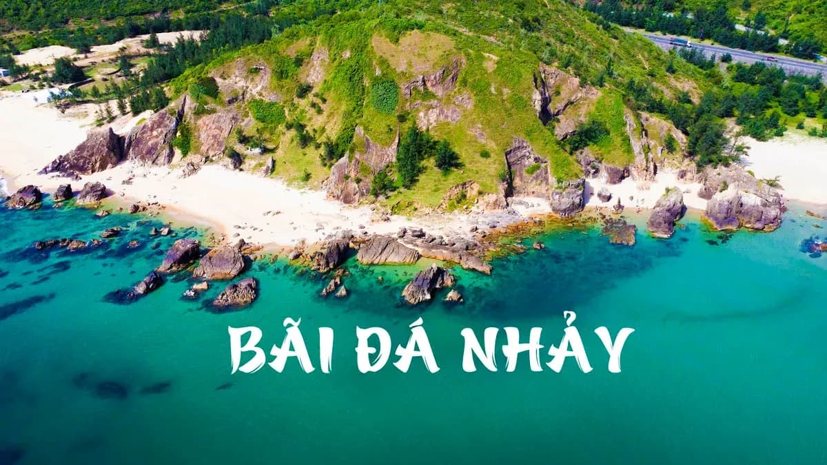 A panoramic view of Bãi Đá Nhảy with mountains and blue sea, alluring visitors.