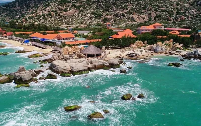 Ca Na Beach viewed from above, featuring striking blue waters and stunning rock formations.