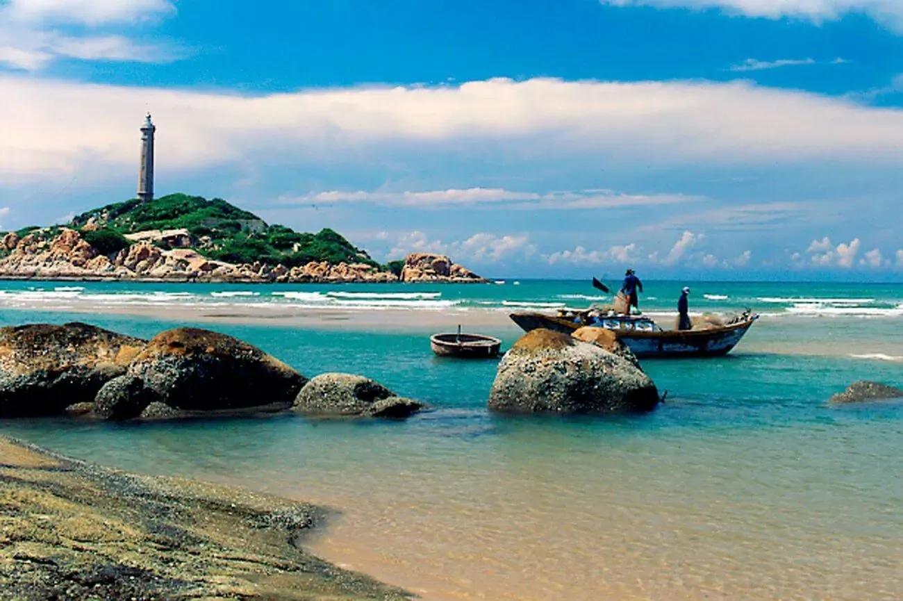 The lighthouse on Thuan An Beach, Hue, surrounded by clear waters and white sands.
