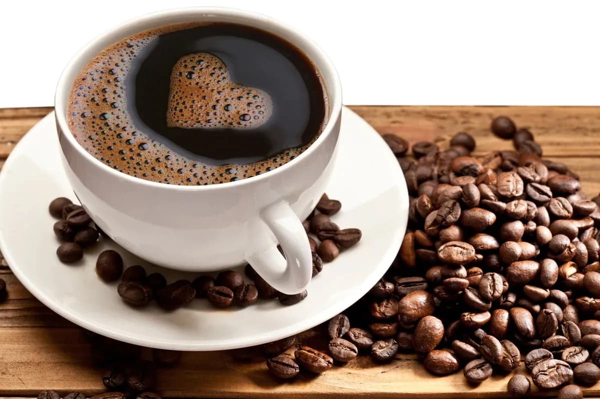 Black coffee with roasted beans and a heart creates a rich and warm feeling.
