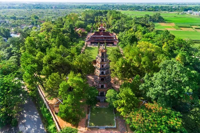 Aerial view of Thien Mu Pagoda amidst lush greenery.