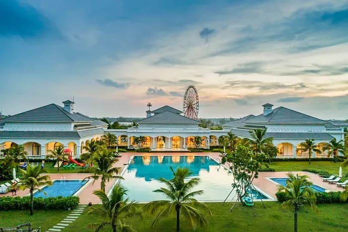 Luxurious resort featuring a large pool and lush surroundings.