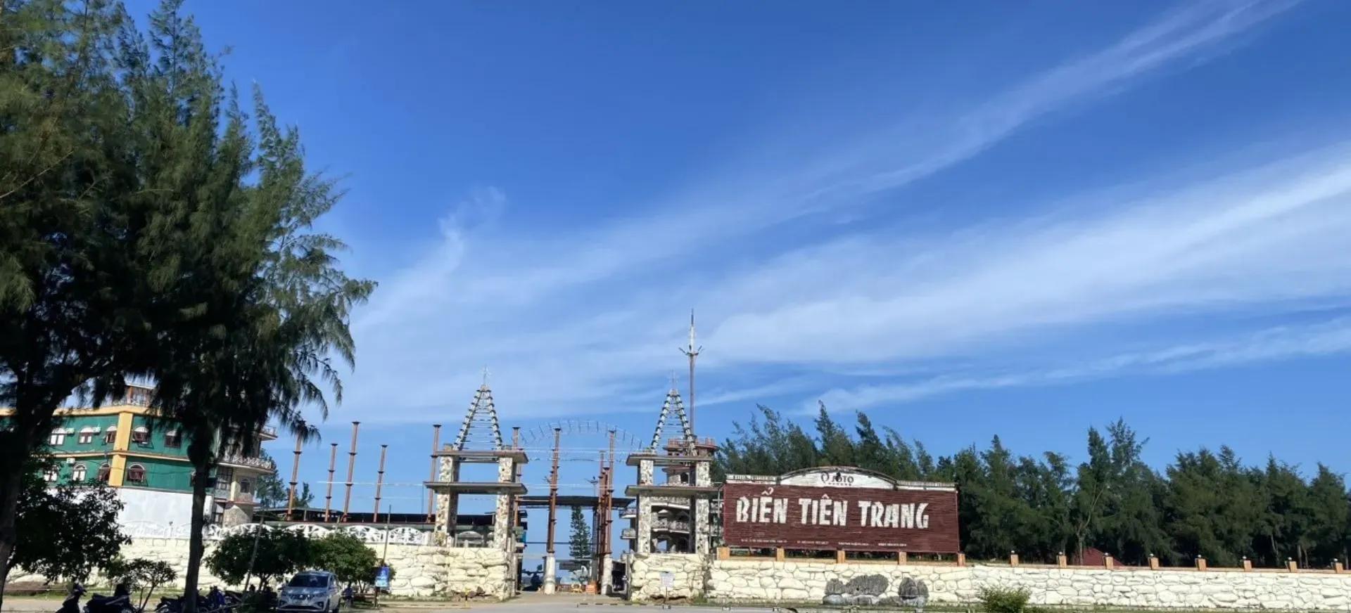 Entrance to Tien Trang Beach, highlighted under a beautiful blue sky.