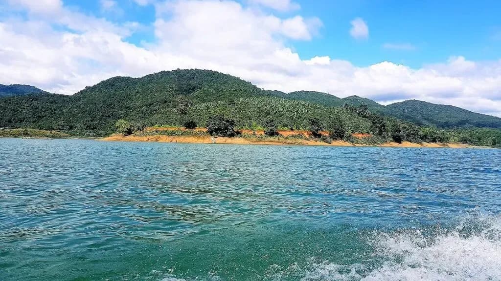 The serene lake surface mirrors the sky at Ham Thuan Lake.
