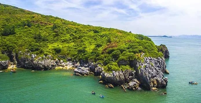 The pristine natural landscape of the coastline with unique rocky outcrops jutting into the blue sea.