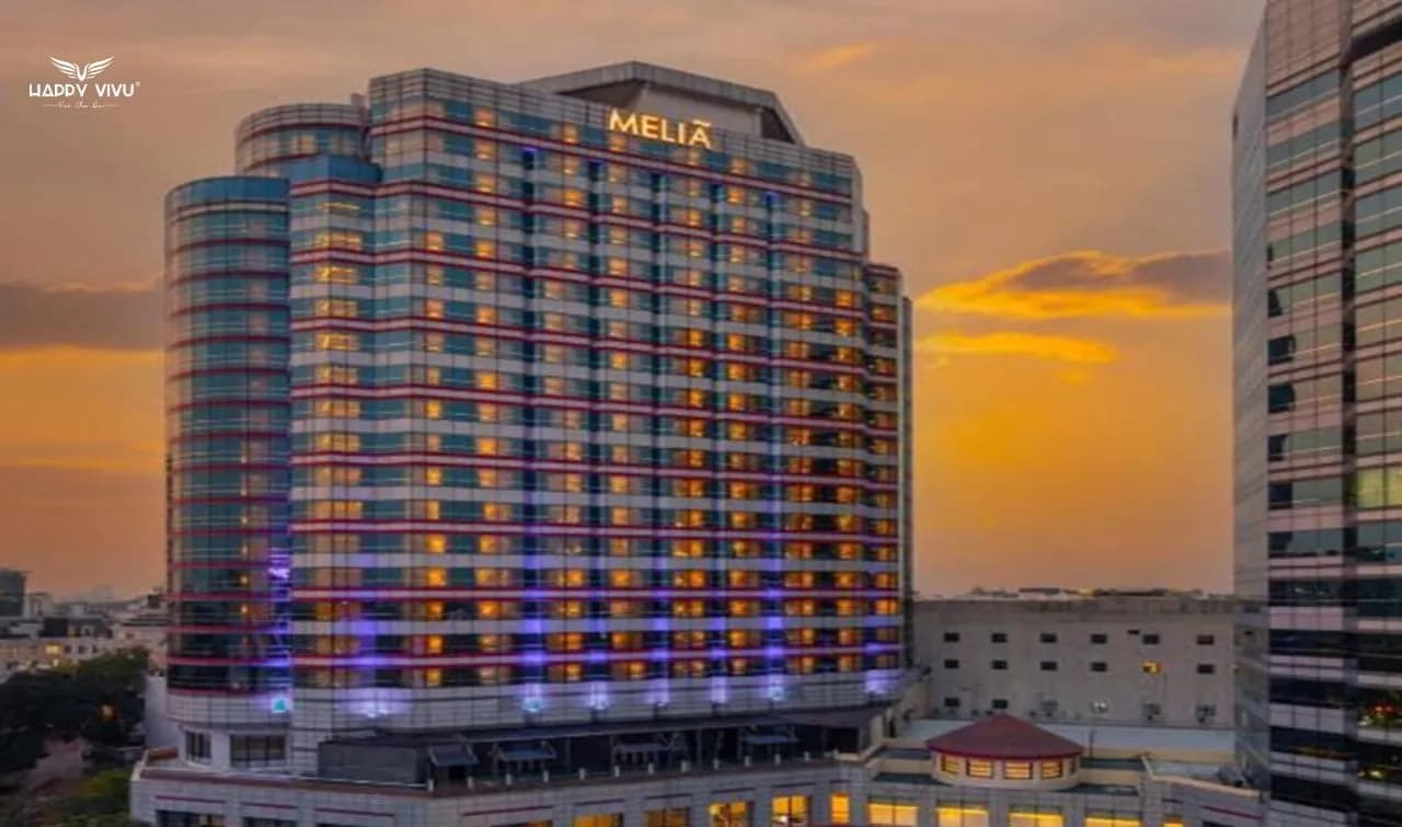 Meliá Hanoi hotel glows under the sunset, showcasing modern architecture in the heart of the capital.