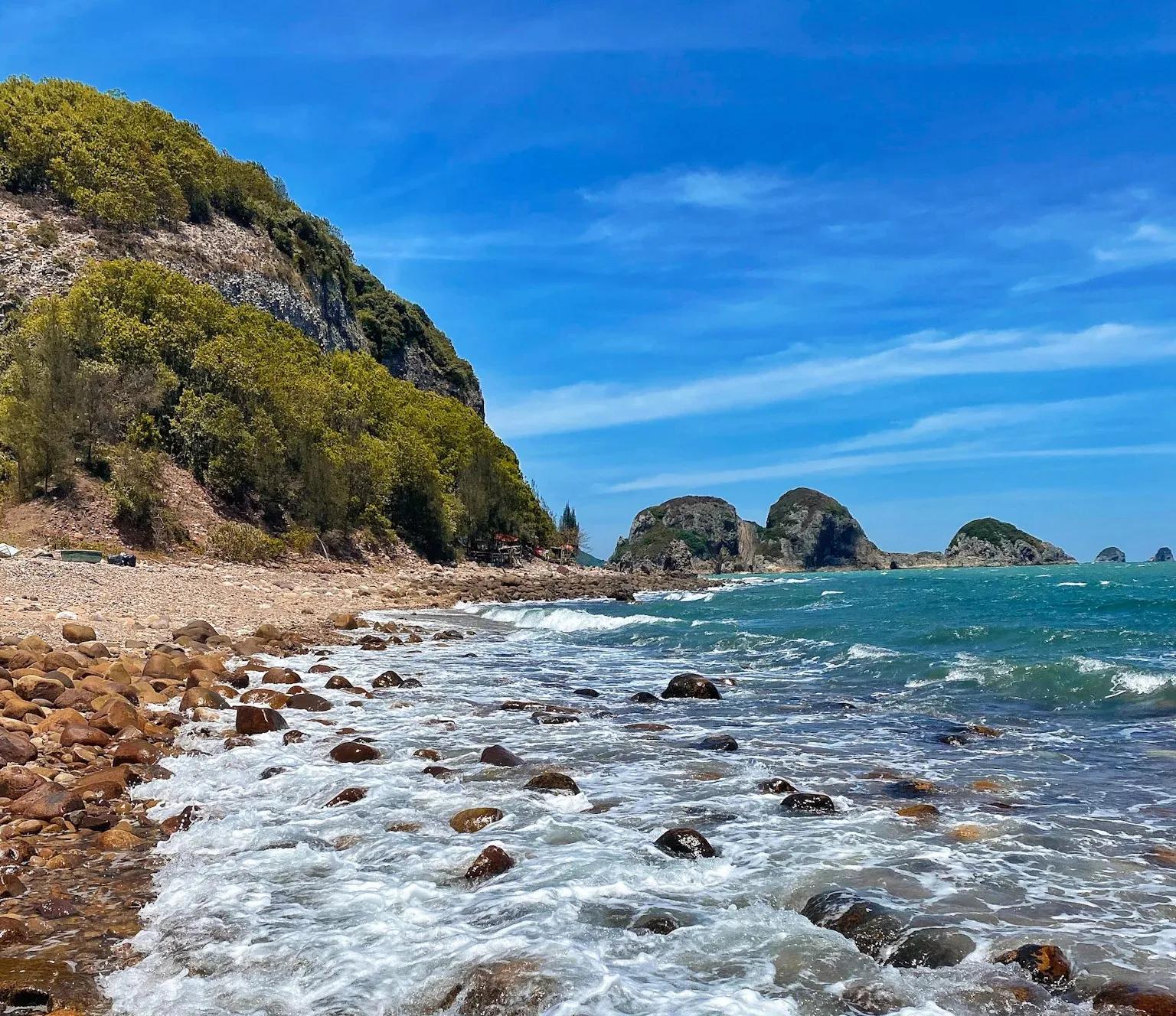 Natural landscape with turquoise sea and rocky shore.