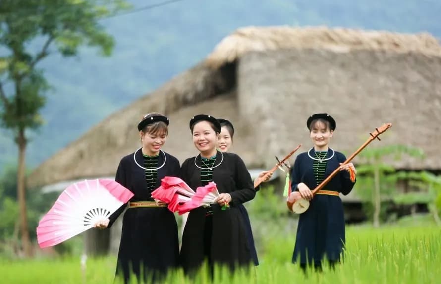 Nung women in traditional attire, holding fans and đàn tính.