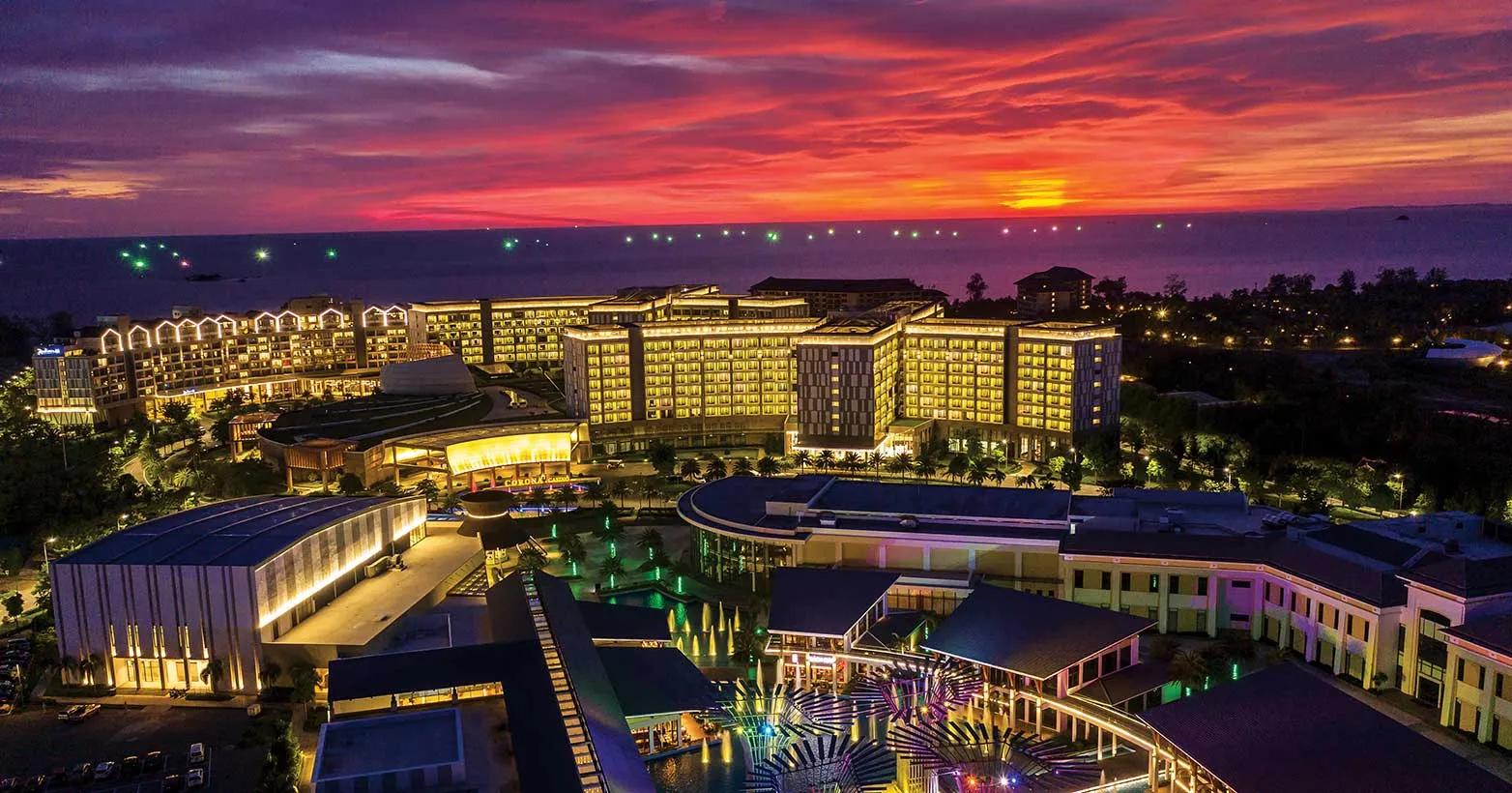 The Corona Phu Quoc luxury casino, with its grand, illuminated entrance, set within a high-end resort, offering a sophisticated and exclusive gaming experience
