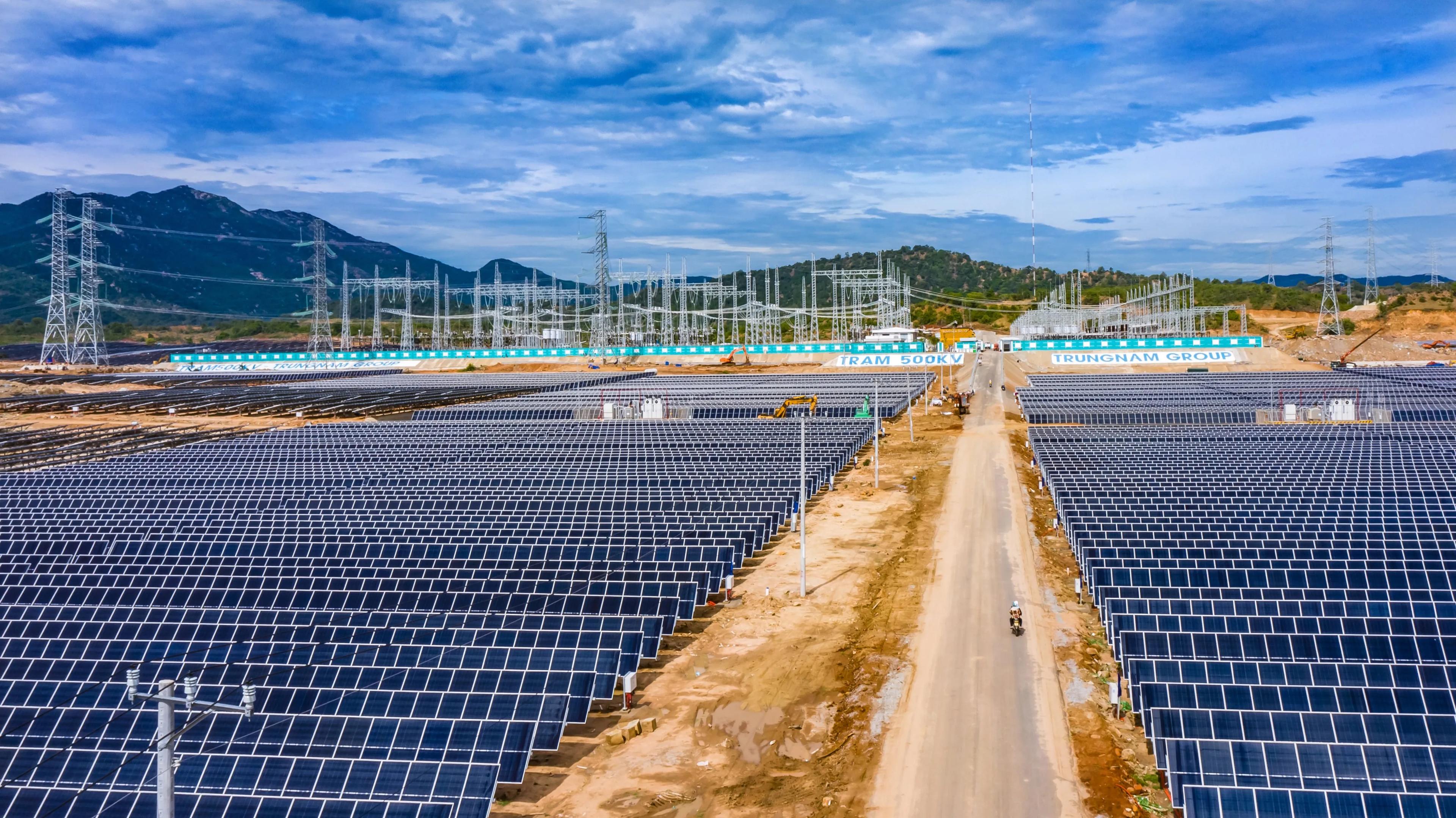 The expansive Trung Nam Solar Power Plant, featuring rows of solar panels stretching across the landscape under a bright sky, showcasing Vietnam’s strides in renewable energy and contemporary infrastructure achievements