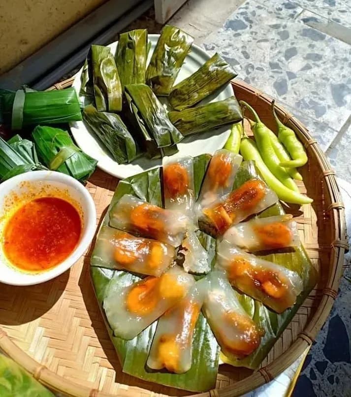Naked and wrapped Banh Bot Loc on a ceramic plate with sauce.