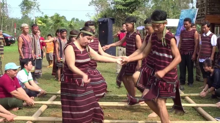 Chơ Ro people in traditional attire participating in a unique bamboo dance.
