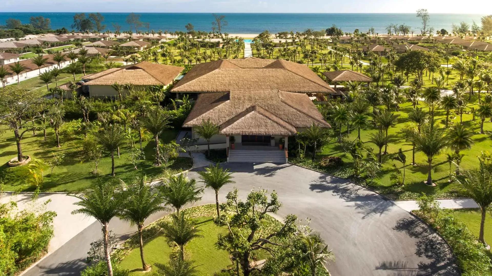 Panoramic beach resort view with lush greenery, open to an endless horizon.