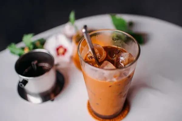 A glass of Vietnamese iced coffee with rich colors and chilling ice.