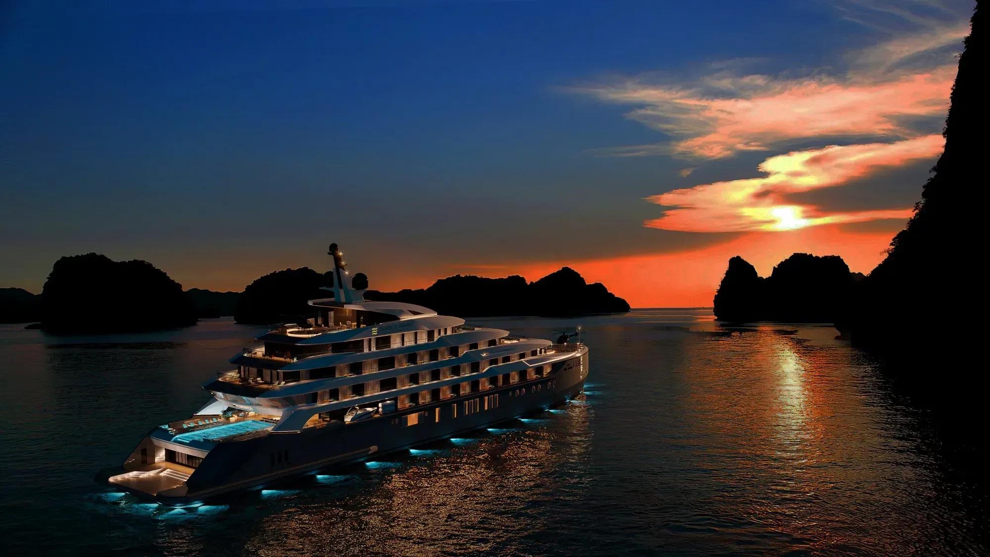 Luxurious yacht Essence Grand Halong Bay Cruise I at sunset on Halong Bay.