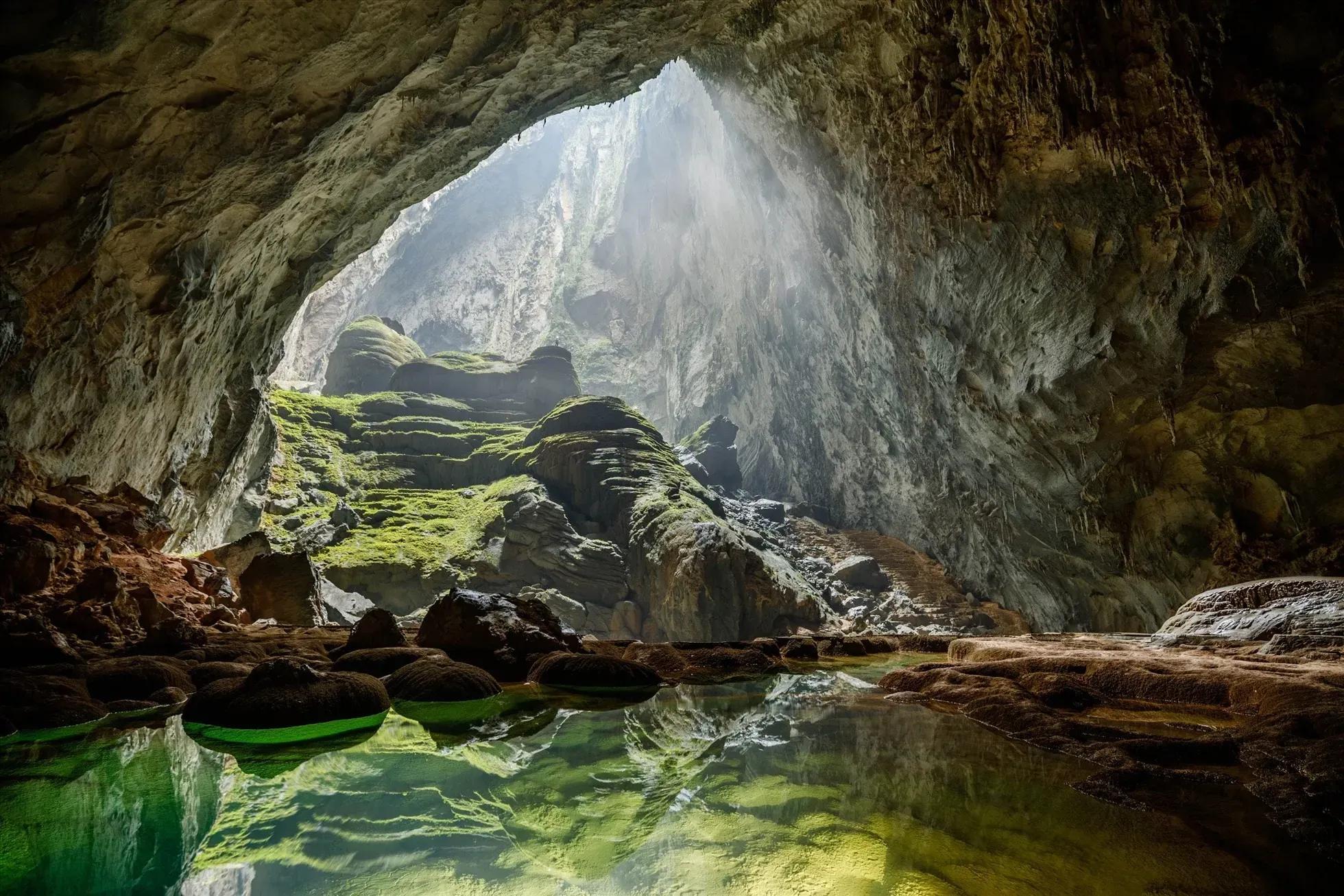 Majestic view of a cave with natural light streaming through the arch.