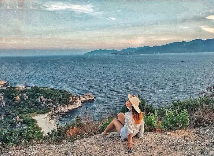 A person sitting on a hill overlooking the endless blue sea of Phu Quoc.