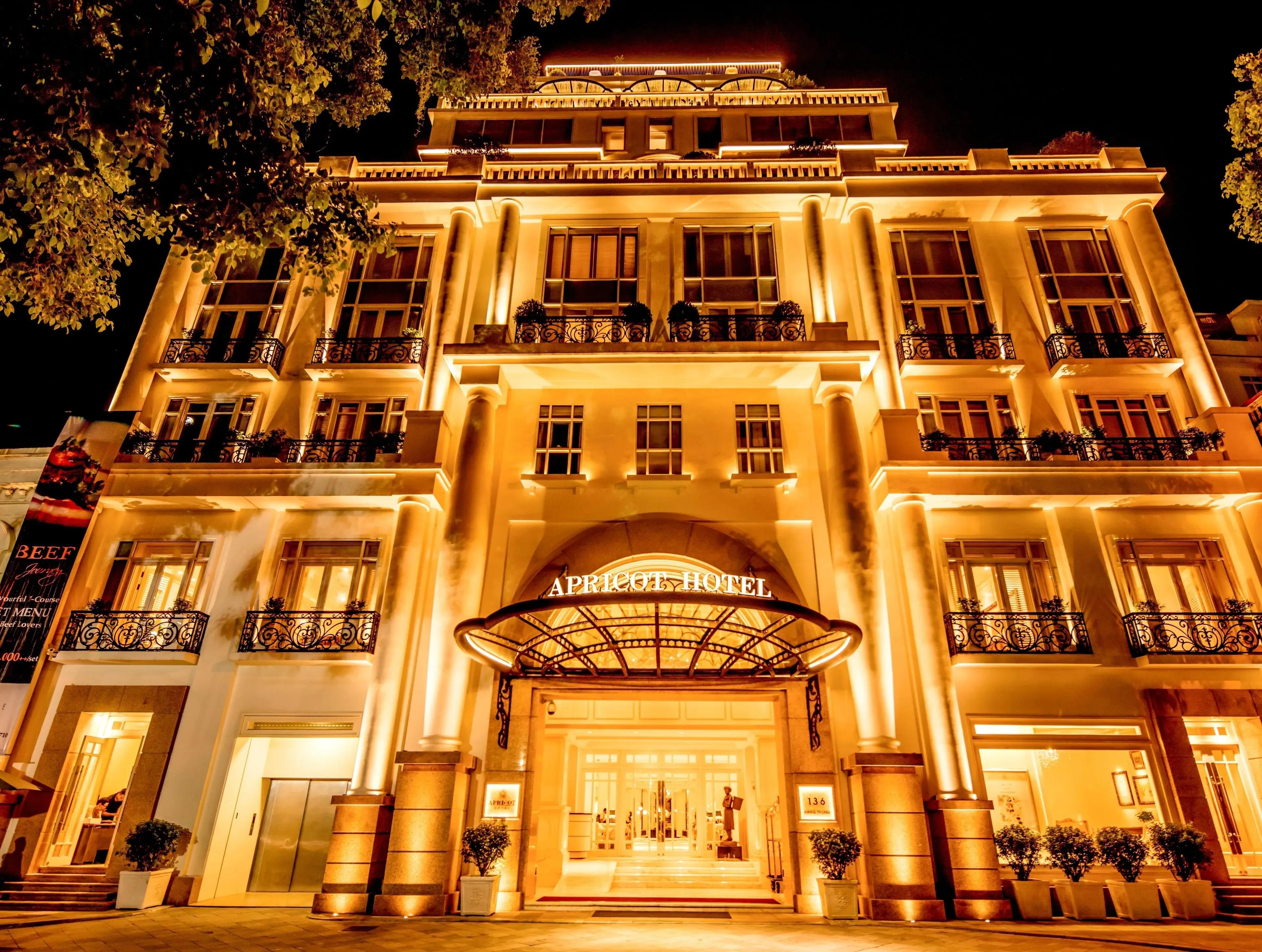 Apricot Hotel Hanoi gleams with golden lights at night, showcasing its classic architecture.