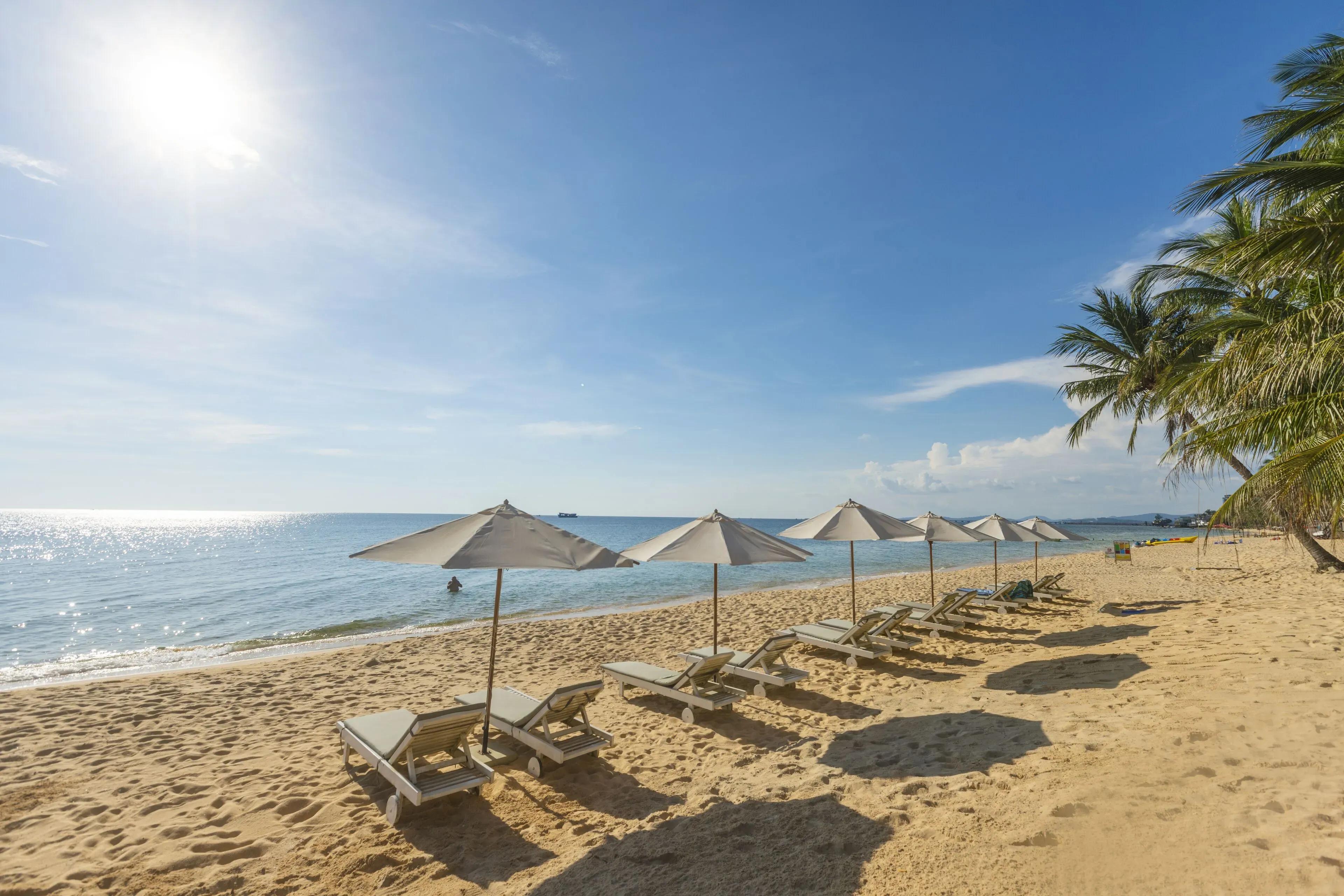 Sunbeds on the beach at Thiên Thanh Phu Quoc Resort under the sunlight.