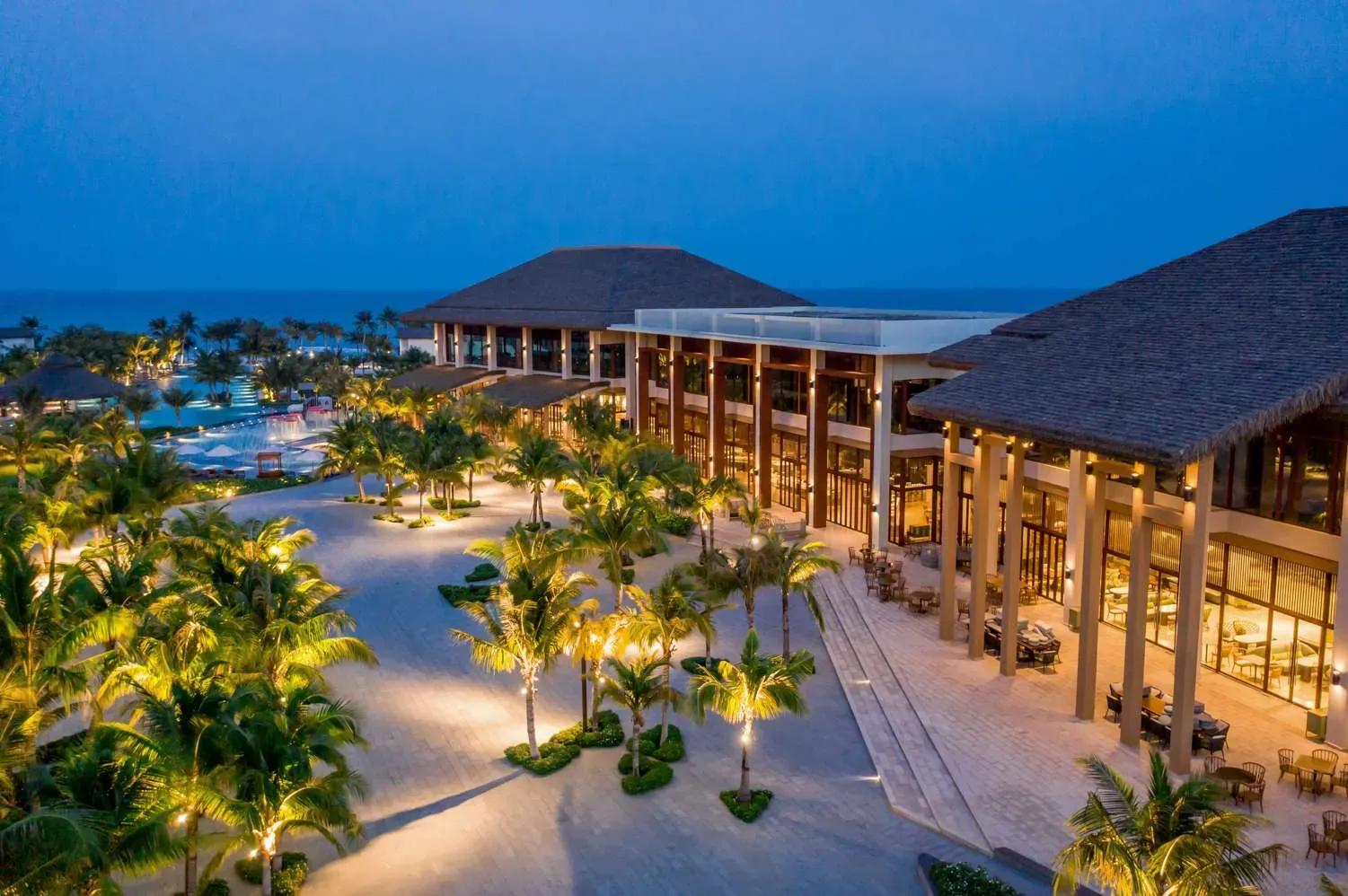 The resort glows warmly at night with open space and inviting ambiance.