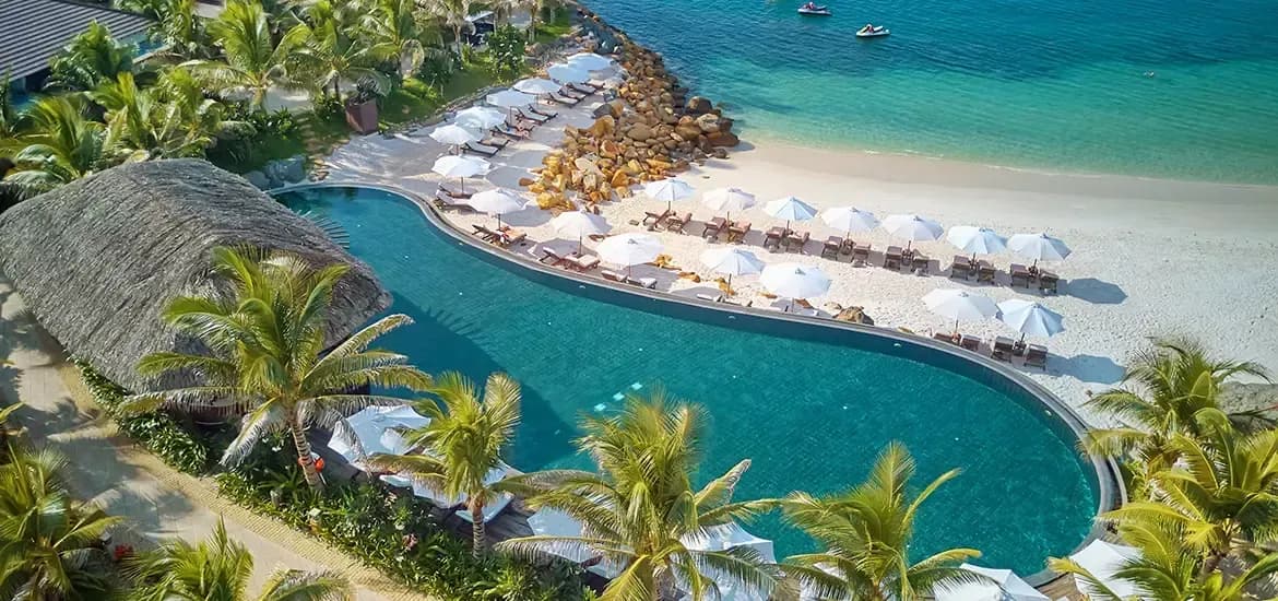 Natural saltwater pool and pristine white sandy beach at Amiana Resort, creating an ideal retreat.