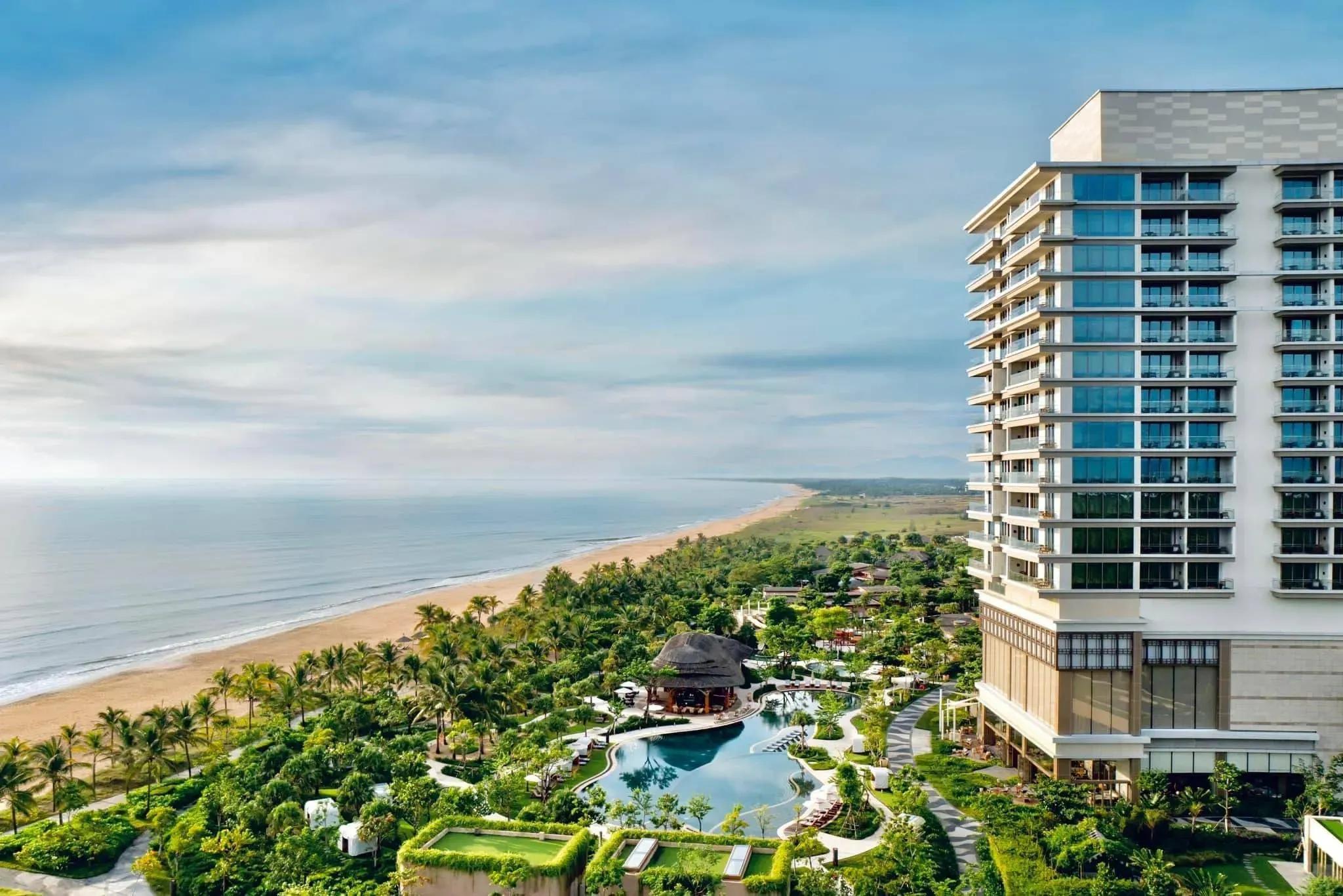 Luxurious coastal resort with a stunning pool and lush greenery.