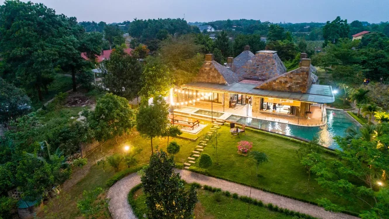 Resort nestled in nature with twinkling lights.