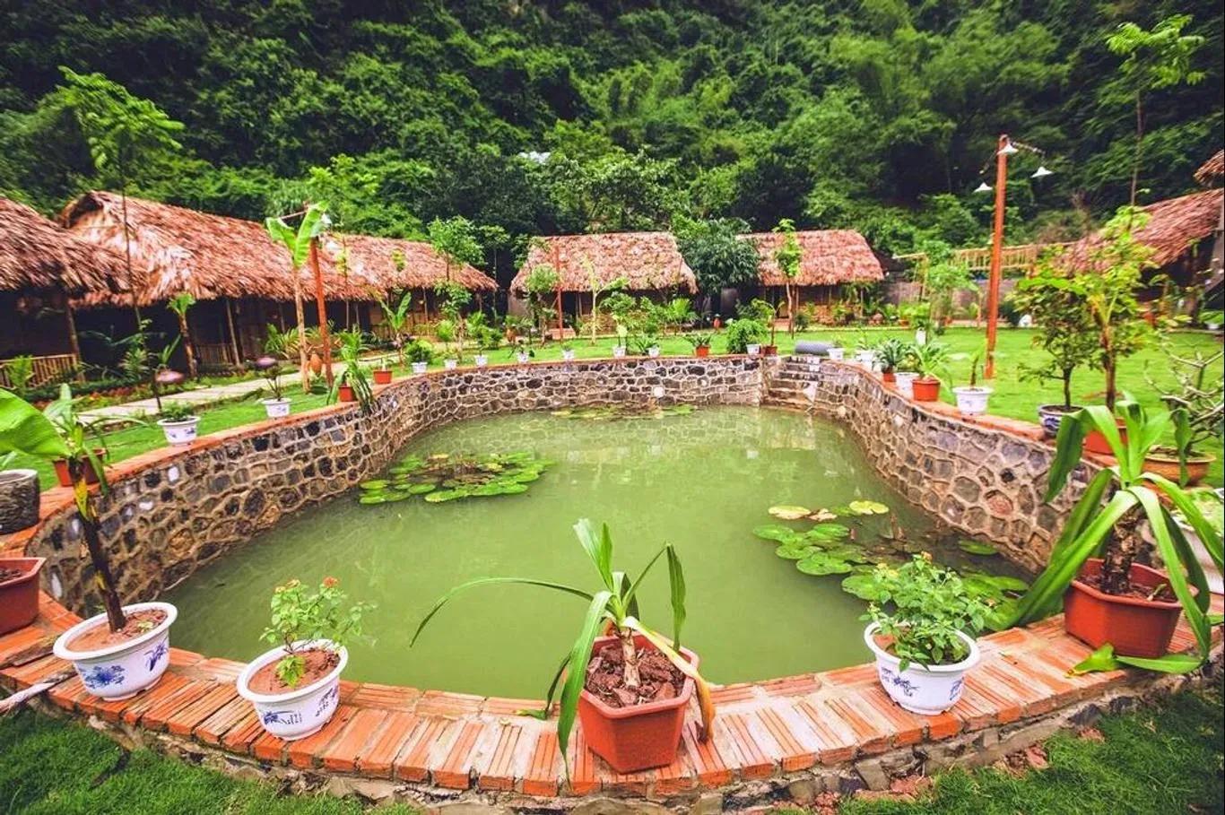 A resort featuring village-style architecture by a serene pond.